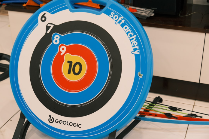 A blue and white soft archery target with a yellow bullseye marked '10' and colorful arrows, illustrating the precision needed for target marketing and customer segmentation.