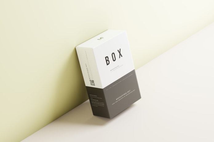 A clean, minimalist white and dark grey product box with BOX printed on it, leaning against a pale green wall on a light surface, representing efficient dropshipping packaging for e-commerce.