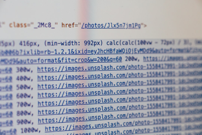 Close-up of a computer screen displaying lines of HTML code with image source URLs and responsive attributes, reflecting the coding process in web development for PSD to WordPress conversion.