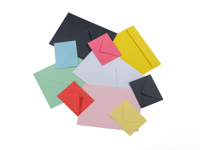 A vibrant pile of multi-colored envelopes, representing diverse project communication and inspiring effective newsletter delivery.
