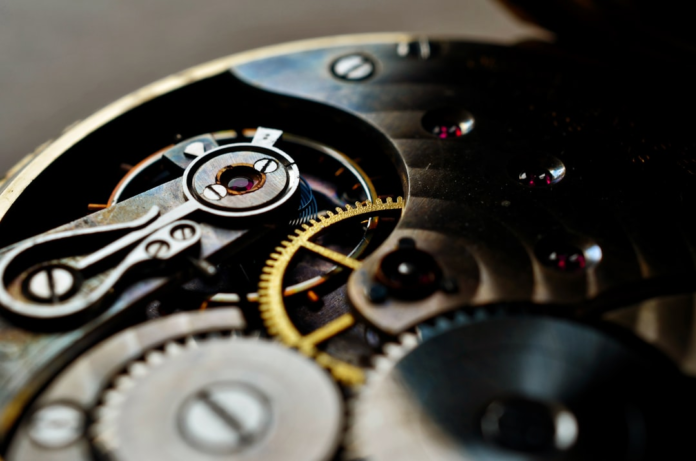 Close-up of an intricate watch mechanism with metallic gears and ruby jewel bearings, symbolizing the precise integration and enhancement of CRM systems like Salesforce.