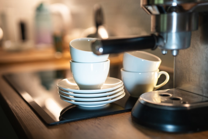 A sleek espresso machine precisely brews coffee on a modern counter next to stacked white cups, setting the scene for focused business growth and daily productivity.